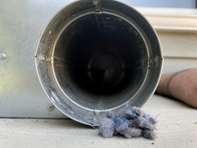 Willowbrook Dryer Vent Cleaning technician using specialized equipment to clear severe dryer vent blockage in Willowbrook